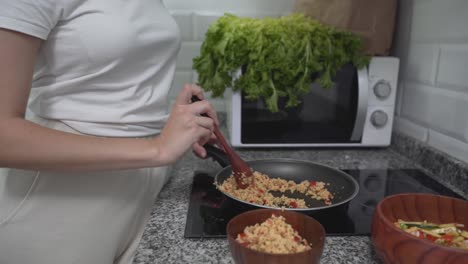 woman eating a healthy meal in the kitchen