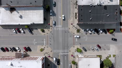 intersection with cars in downtown cadillac, michigan with drone overhead shot stable