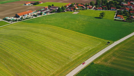 The-beauty-of-western-Germany's-countryside-on-a-sunny-day-with-aerial-footage-capturing-a-tractor-and-harvested-fields
