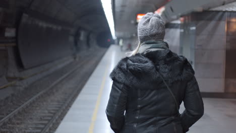 woman waiting for a train at a subway station