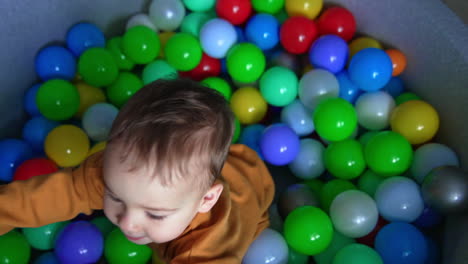 baby in a colorful ball pit