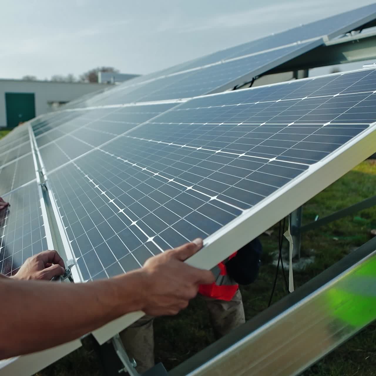 Workers installing solar panels outdoors
