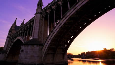gothic bridge over river at sunset or sunrise