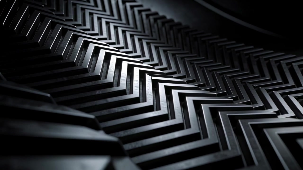 Telecamera in panning che rivela piastre metalliche a forma di chevron a V in studio, mostrando bagliori e profondità.