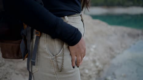 woman hiking near a lake with a watch