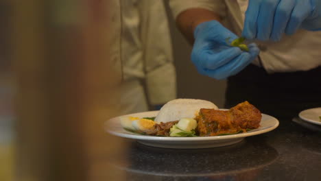 Bowel-of-rice-plating-on-banana-leaf-eggs-and-curry-dish-South-Indian-food-garnishing