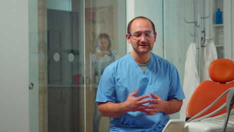 Dentist-nurse-looking-at-camera-talking-about-dental-hygiene