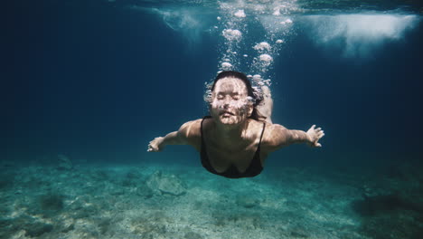 woman diving underwater