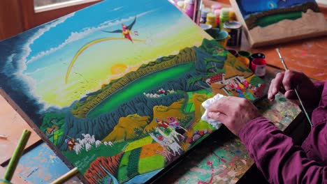 close up shot of a painters hand finishing a japanese art