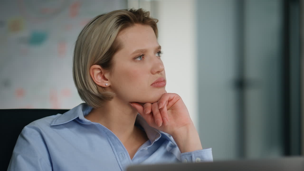 Thoughtful businesswoman thinking work issue sitting company workspace close up.