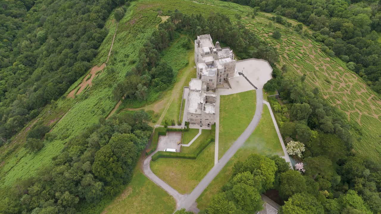 Aerial View of a Historic Castle on a Forested Hill