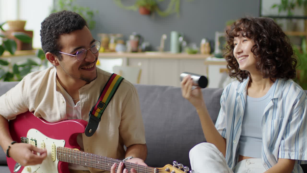 Gen Z Couple Playing Musical Instruments at Home