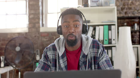 focused african american casual businessman having laptop video call in office in slow motion