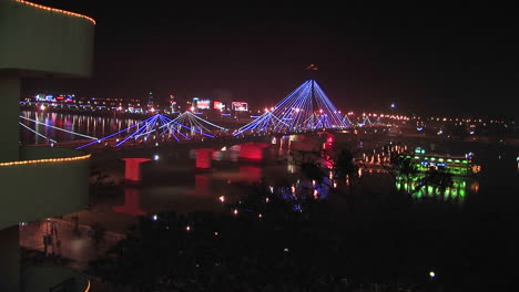 view from an apartment of a bridge over a river at night