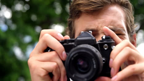 young man photographing with a camera