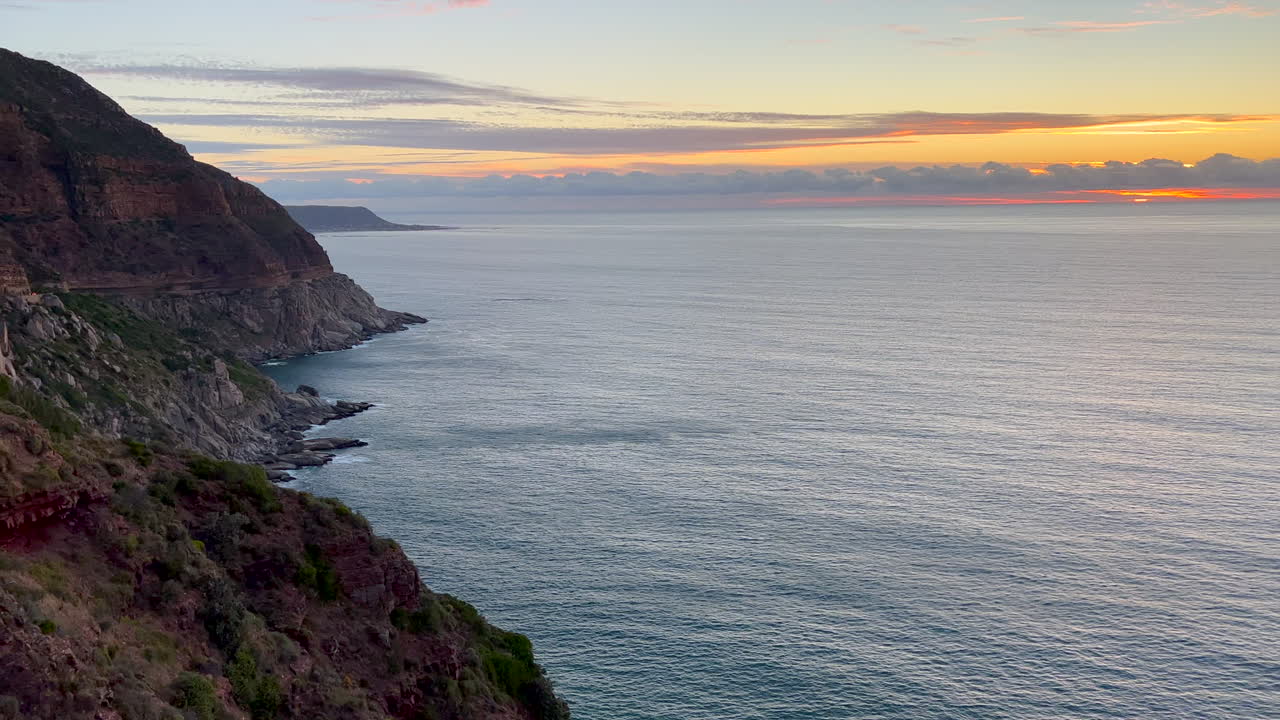 Chapman Peak Drive sunrise sunset Noordhoek Hout Bay Marina scenic Table Mountain epic travel road coastline cliffside view Cape of Good Hope South Africa lush spring summer cinematic pan right slowly
