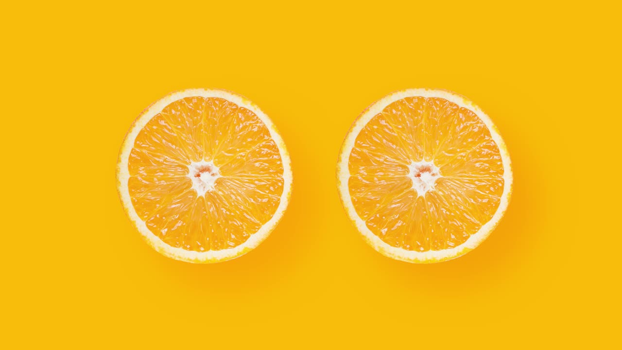 Two sliced ​​oranges rotating on orange background.Top View. 4K