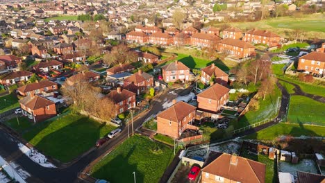 drone's-eye winter view captures dewsbury moore council estate's typical uk urban council-owned housing development with red-brick terraced homes and the industrial yorkshire