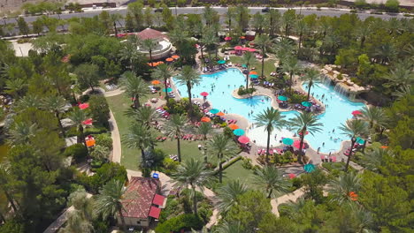 Sideways-drone-footage-of-people-enjoying-a-resort-pool
