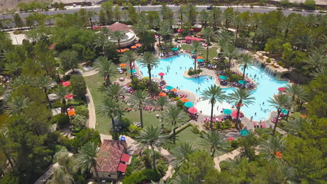 sideways drone footage of people enjoying a resort pool