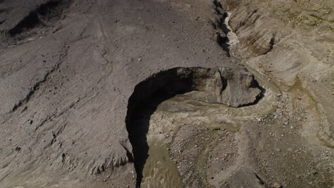 aerial view of glacier water muddy lake, debris cover on the glacier in eastern alps, alpine lake stream, austria