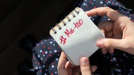 hand holding notepad with #metoo