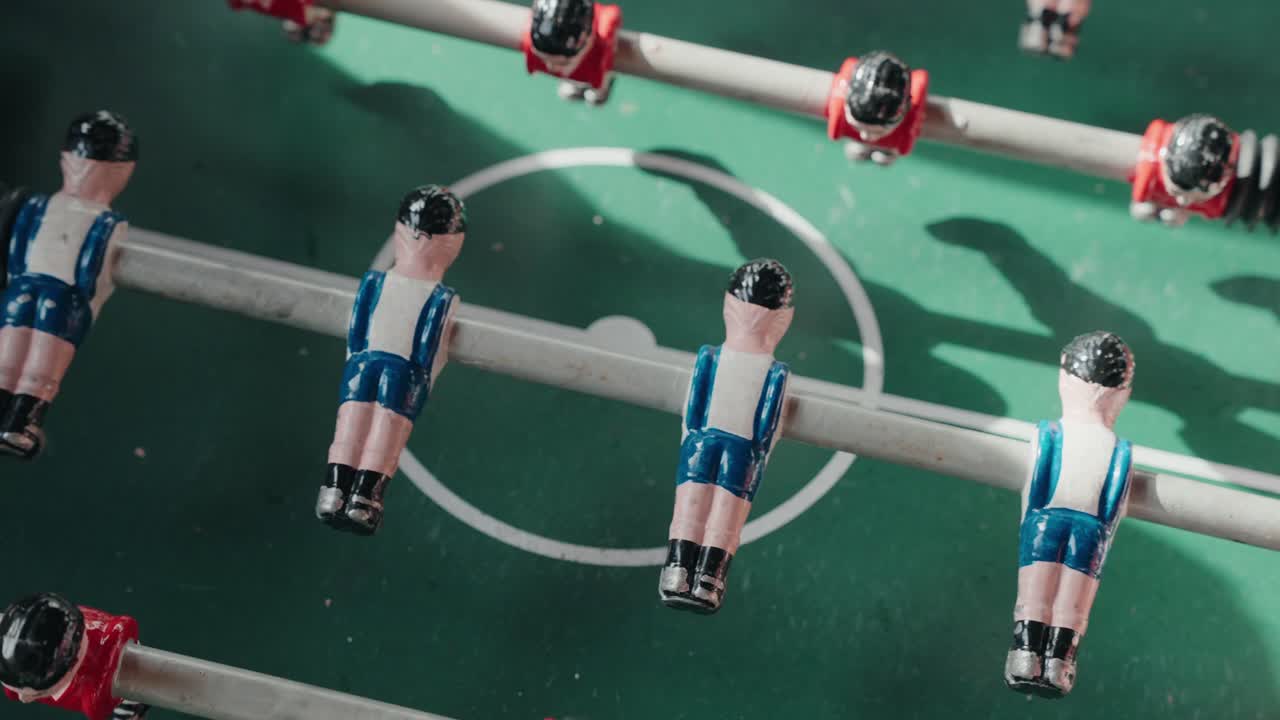 Close up overhead tabletop soccer foosball figures on green playing field