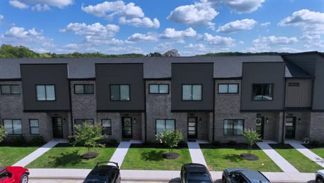 row of modern upper class houses and homes with parking cars in front