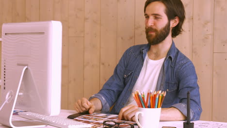 hipster worker using video chat at desk