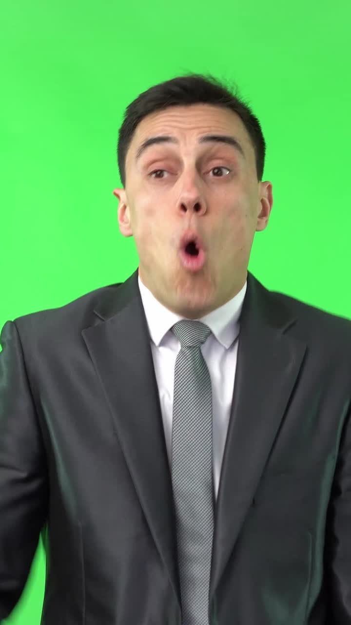 Businessman Displays a Range of Emotions on a Green Screen