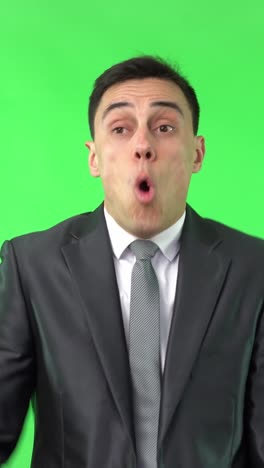 businessman displays a range of emotions on a green screen