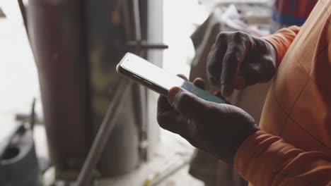 African-man-looking-at-touch-pad-at-work