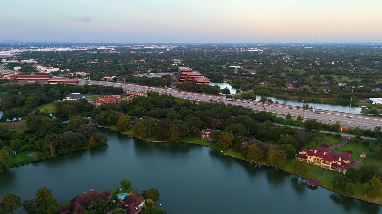 An aerial view of a unique architectural building, near a body of water.