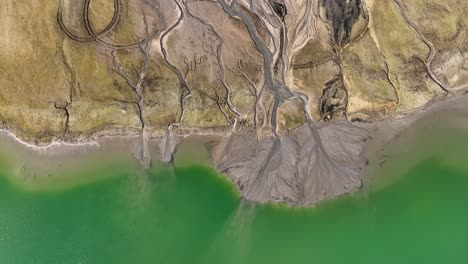 drone rotate above stunning water green lake with geological earth stone formation