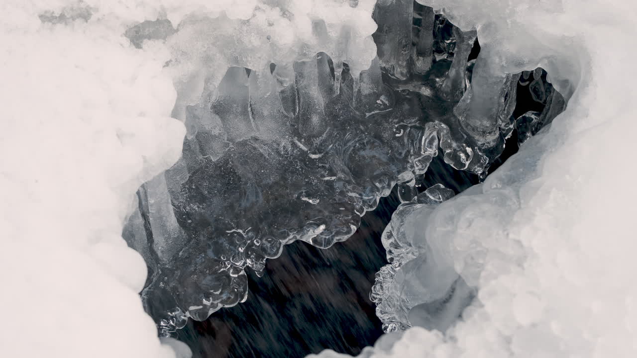 agua que fluye bajo el hielo derretido de cerca