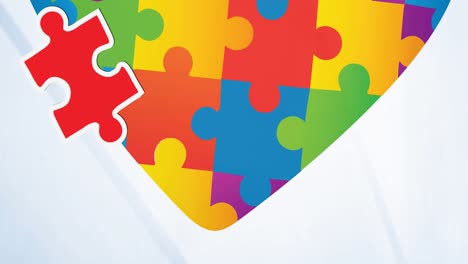 animation of red and yellow puzzles falling over heart in autism awareness puzzles