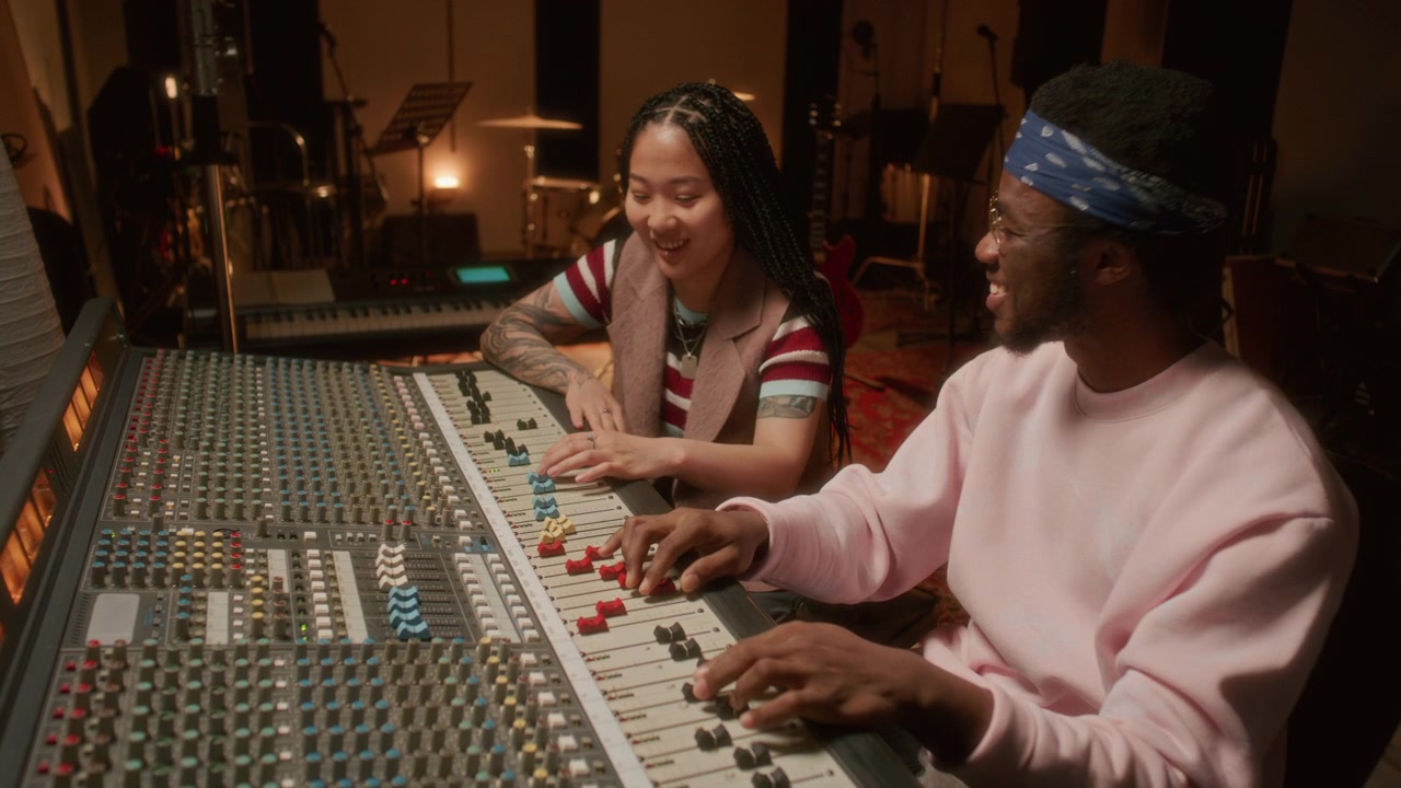 Music Producer and Audio Engineer Recording Tracks during Studio Session