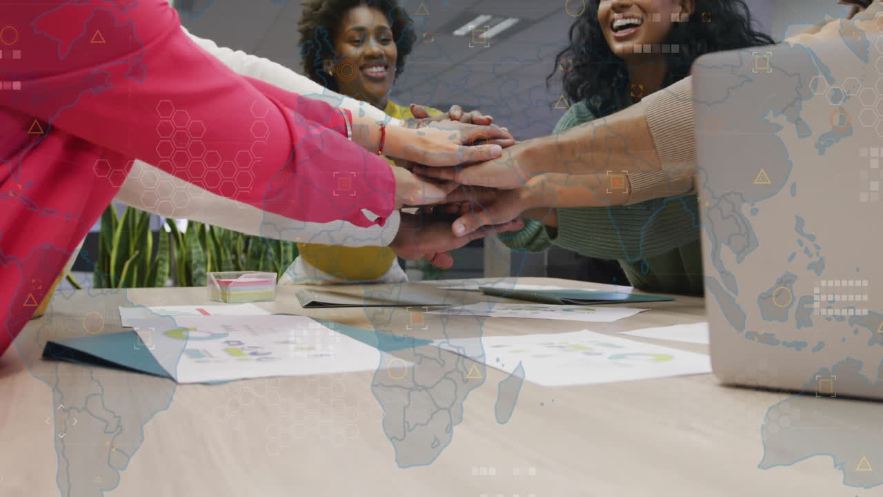 Diverse team celebrating success with hands together over global network animation