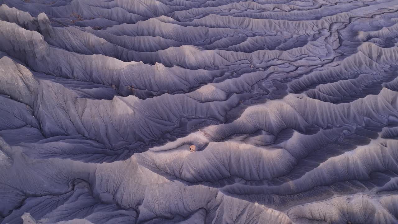 Textured purple Utah desert terrain at dusk, aerial view