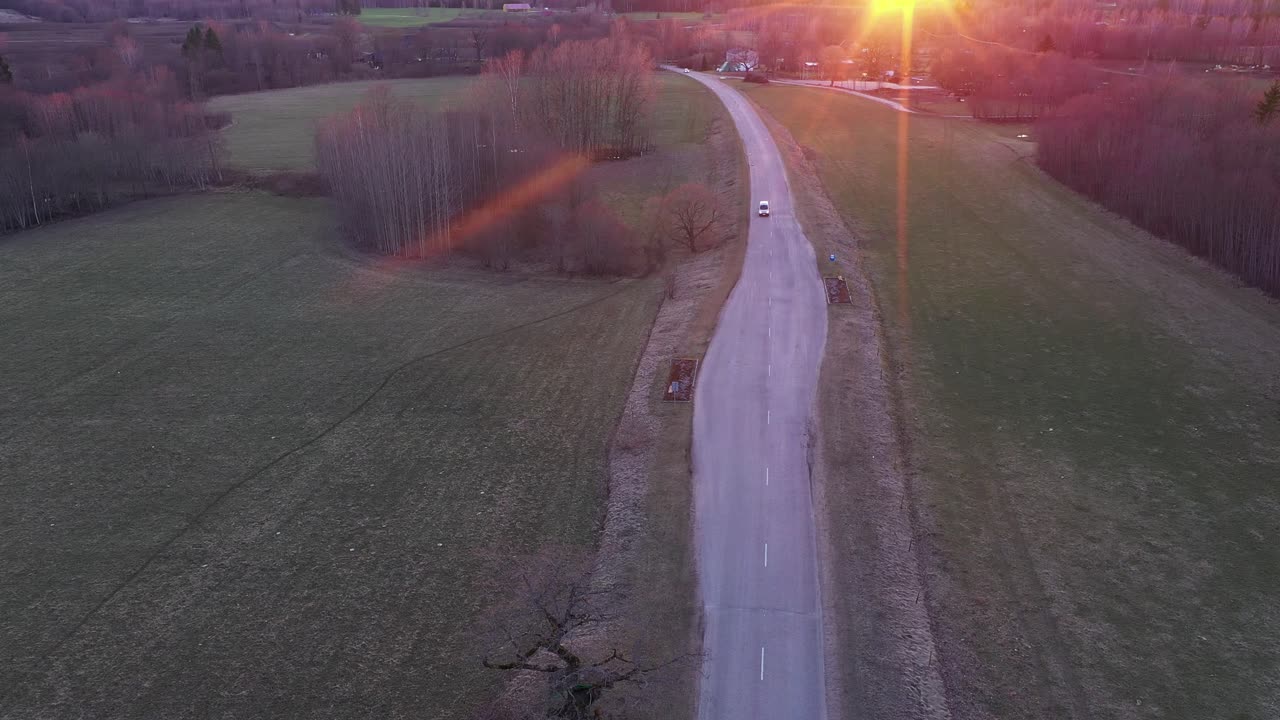 Countryside road during red sunset in aerial drone view