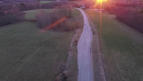 countryside road during red sunset in aerial drone view