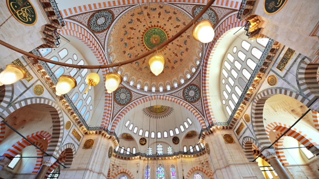 Interior view of the Suleymaniye mosque in Istanbul, Turkey. A lot of illumination, painted ceiling