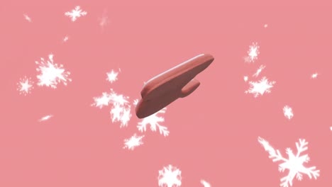 Animation-Von-Lebkuchenplätzchen-Mit-Weihnachtsmannmütze-über-Schnee,-Der-Auf-Rosa-Hintergrund-Fällt