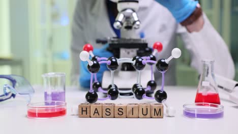 hassium molecular model and lab equipment in a science laboratory