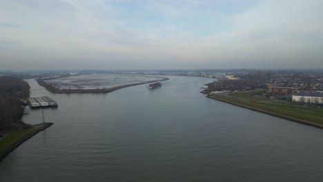 Aerial-view-of-the-New-Hampshire-cargo-ship-on-the-river-in-Dordrecht,-Netherlands
