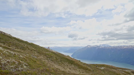 epic mountain biking adventure above the fjords near sogndal, norway. rider tackles rugged trails surrounded by dramatic cliffs, lush green hills, and stunning nordic scenery