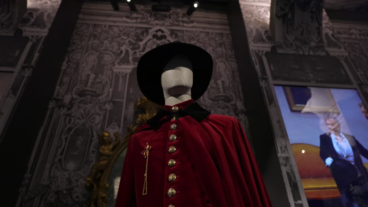 Historical Red Cape and Hat on Mannequin in Museum Exhibition