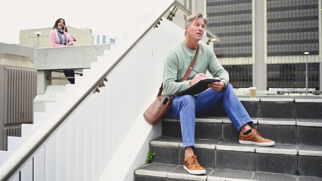 Placing coffee cup White man scribbling on tablet steps Latina woman with tote calling smartphone