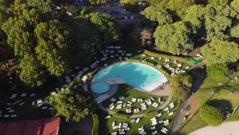 backwards shot of stunning blue swimming pool at amigos club in buenos aires, argentina