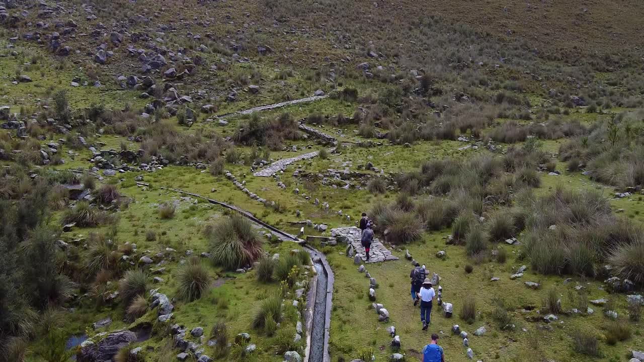People Walking In The Trail Along The Stream In The Mountain. - aerial